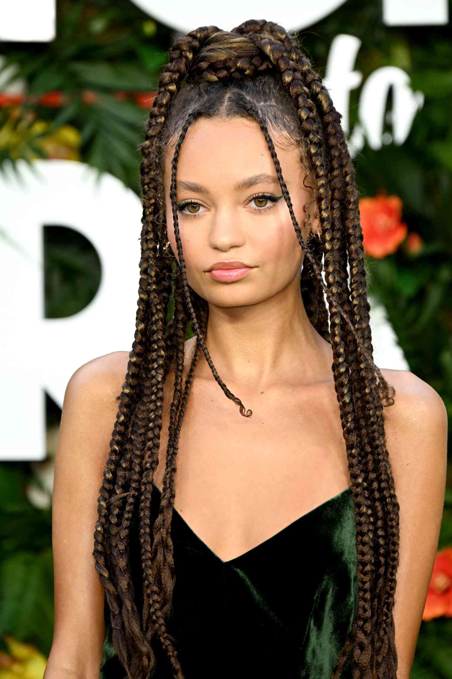 Nico Parker with a braided brown and blonde updo