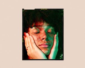 woman holding face in light