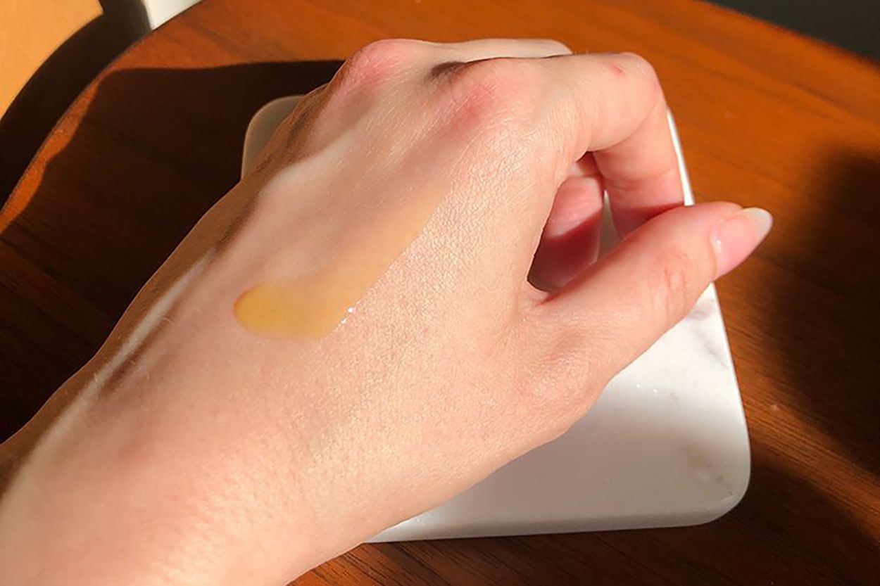 Skin Ceuticals C E Ferulic drops on hand on top of coaster