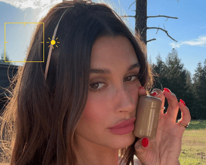 Hailey Bieber holding a Rhode Pocket Blush.