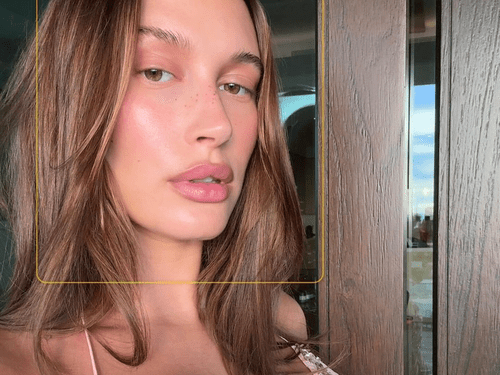 Hailey Bieber wearing pink makeup. 