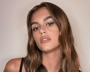 Kaia Gerber with long brown hair.