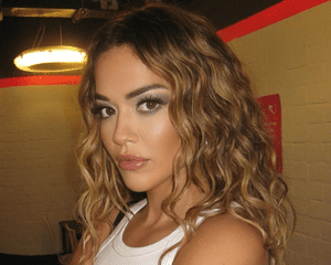 Rita Ora with wavy hair.