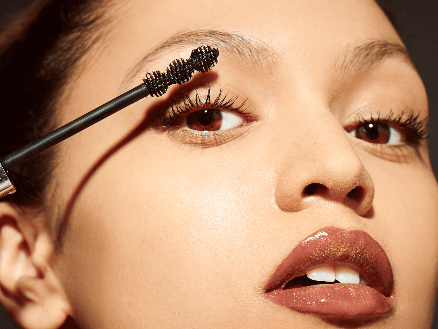 Woman applying mascara