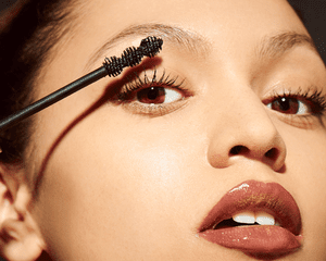 Woman applying mascara